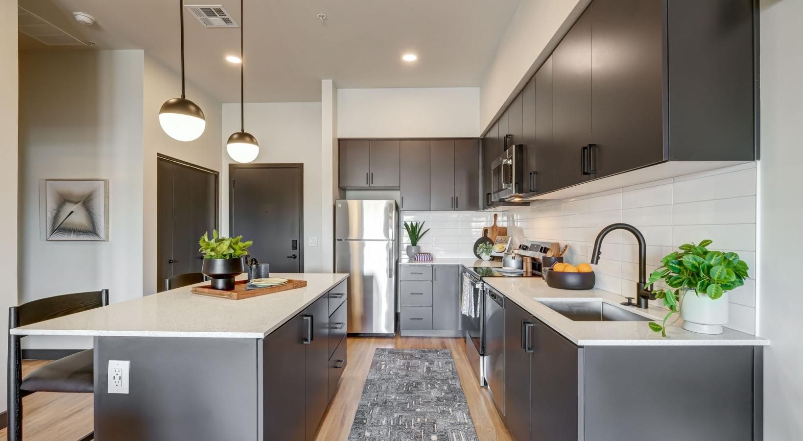 Spacious kitchens with thoughtful details a kitchen with a bar and a table