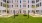 a building with a lawn and hammocks