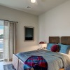 a bedroom with a nightstand, dresser and a window