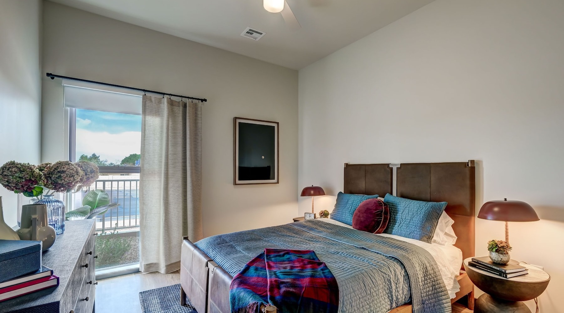 Generous bedroom offerings to fit every family a bedroom with a nightstand, dresser and a window