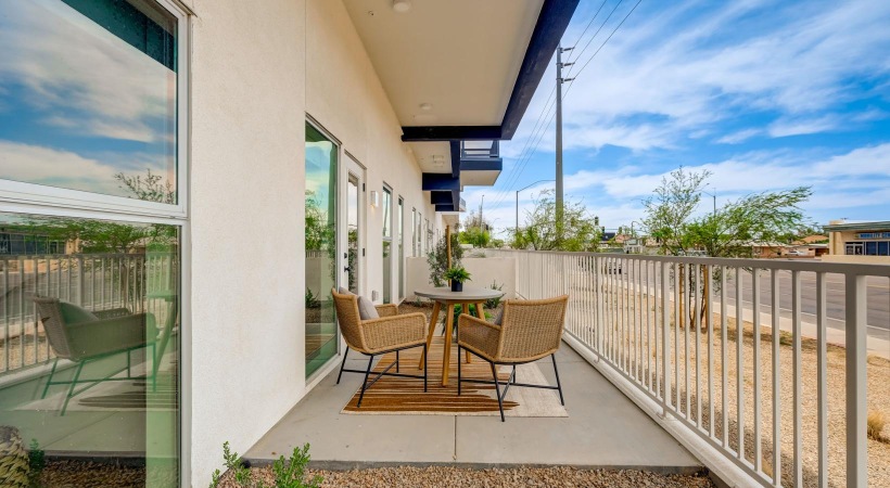 a patio with a table and chairs