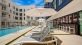 a pool with chairs and umbrella