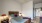 a bedroom with a bed and lamps