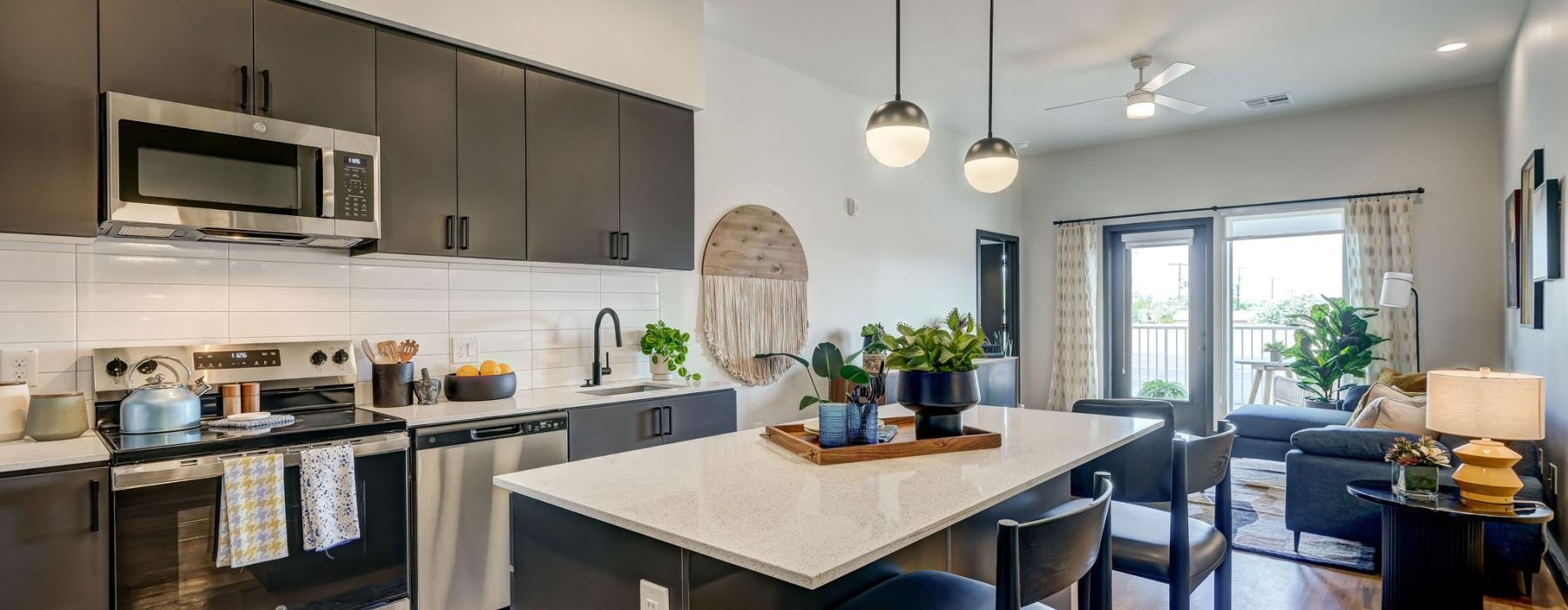 a kitchen with a bar and chairs
