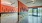 a room with orange walls and glass windows