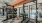 a gym with glass doors and a bench in it