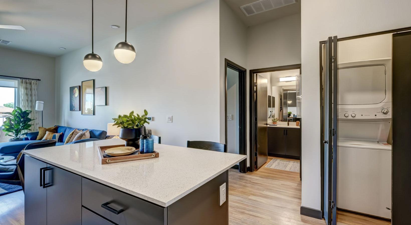 Washers and dryers available a kitchen with a large island and a washer and dryer in a closet