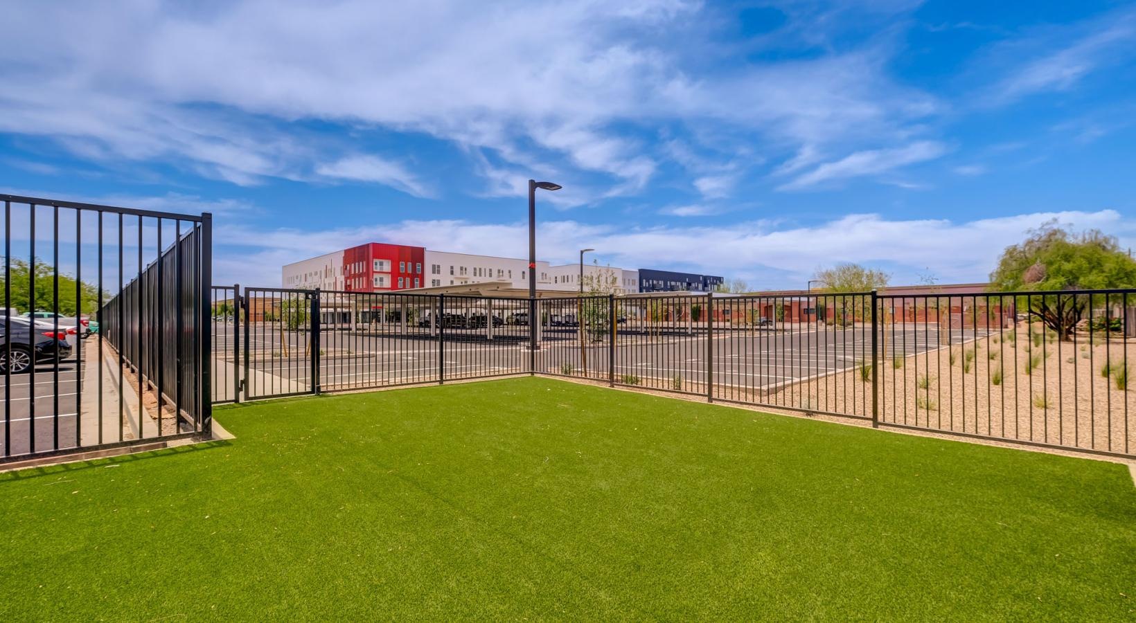 Settle into comfort at The Pomeroy a fenced in area with a building in the background
