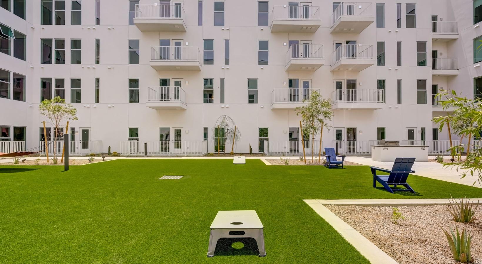 Take advantage of all The Pomeroy has to offer a building with a lawn, games and chairs