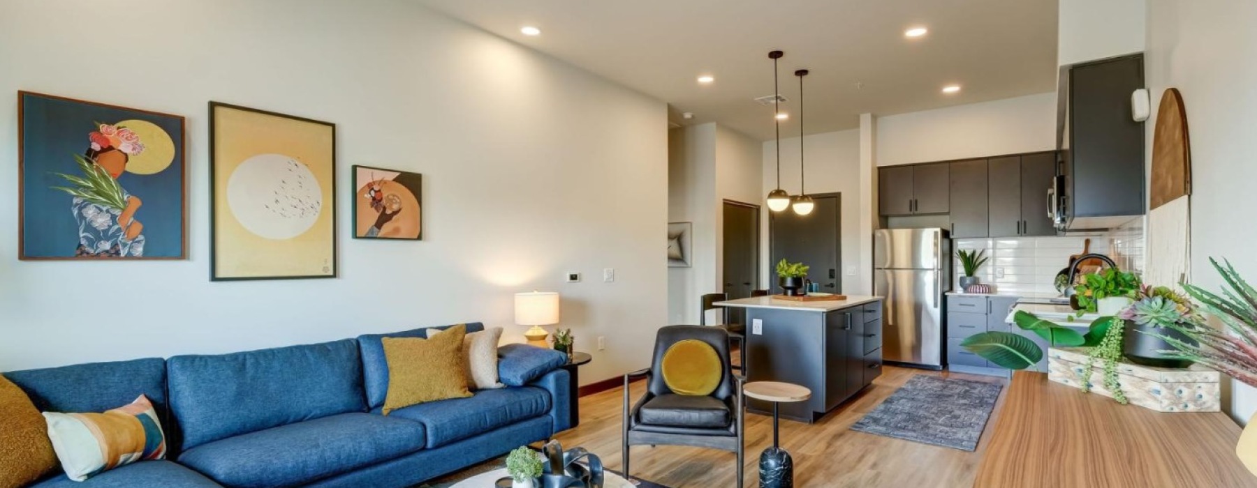 Modern luxury living room and kitchen at The Pomeroy apartments in Mesa, AZ.