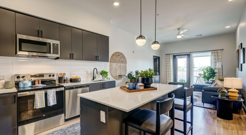 Beautiful living areas to match your lifestyle a kitchen with a bar and chairs