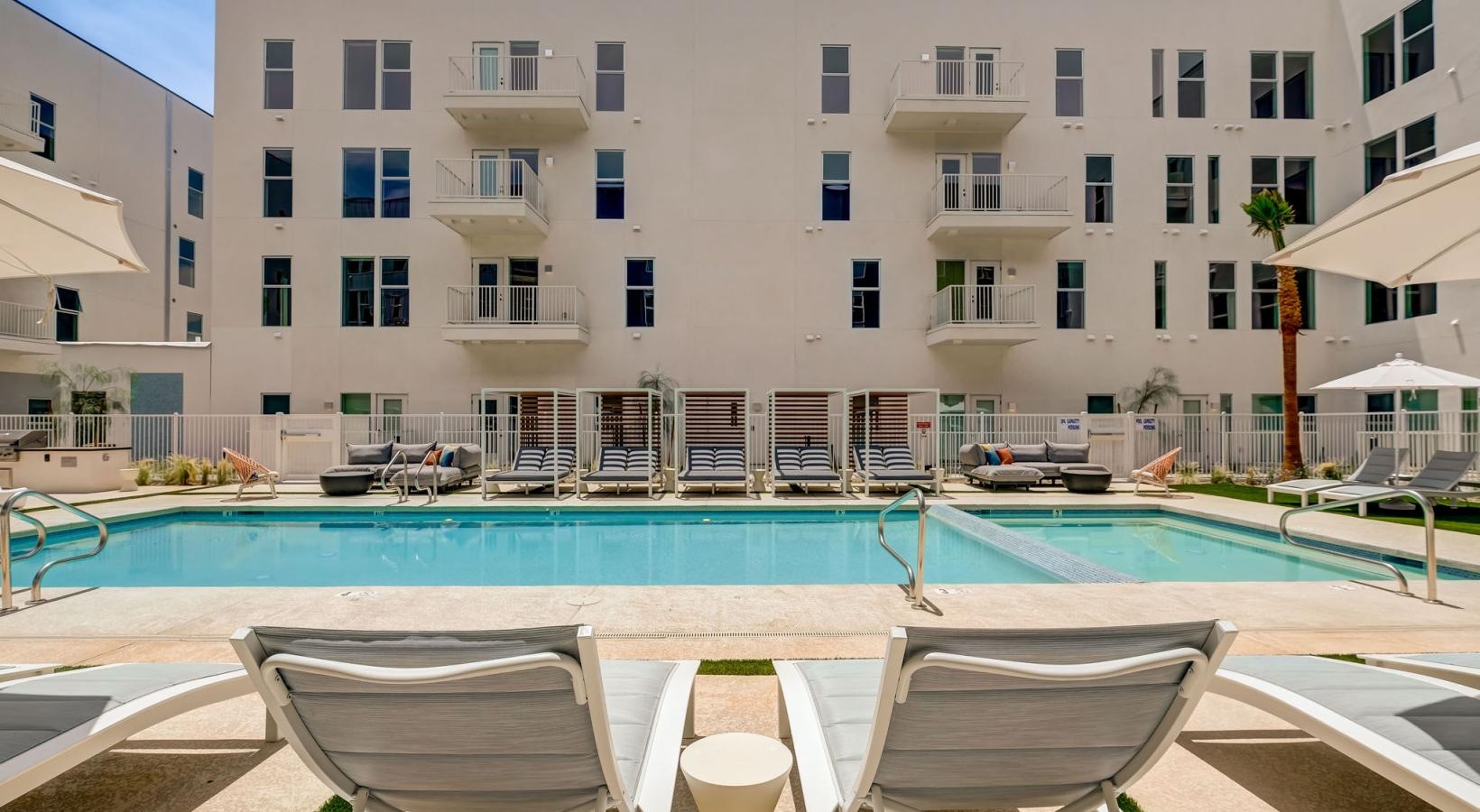 Sparkling swimming pool a pool with chairs around it
