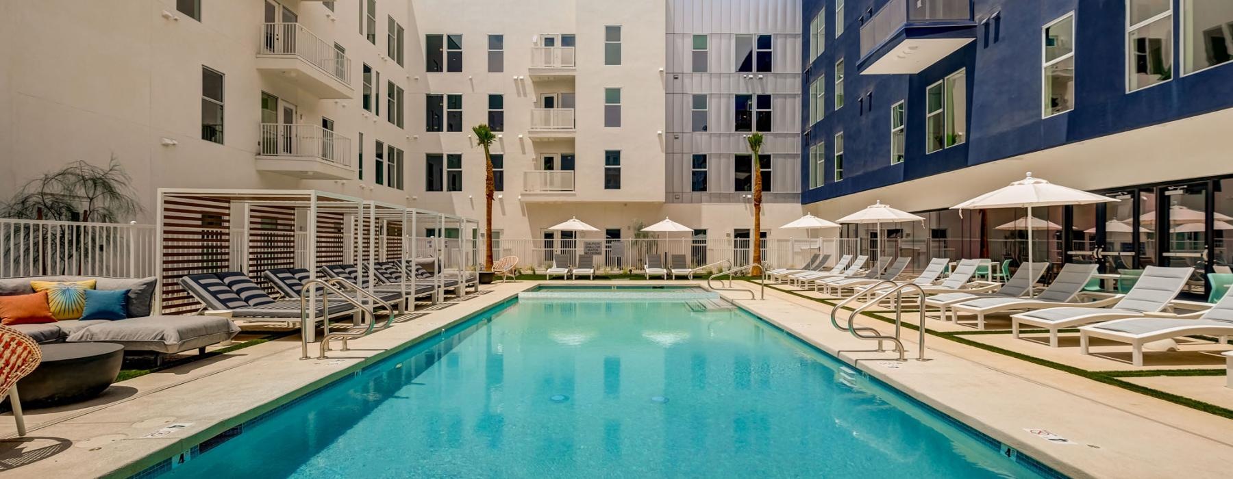 a pool in a courtyard with buildings around it